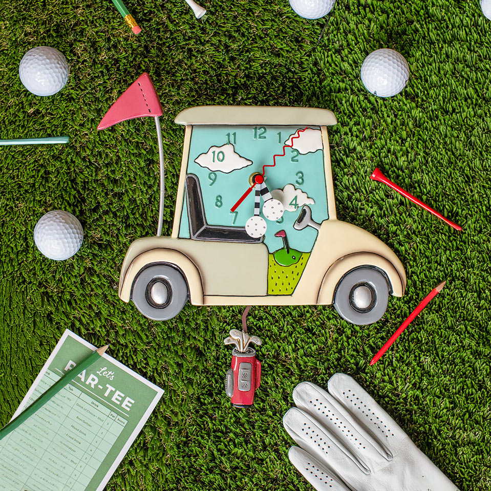 Golf-themed clock with golf cart design on a grass background with golf balls and clubs.